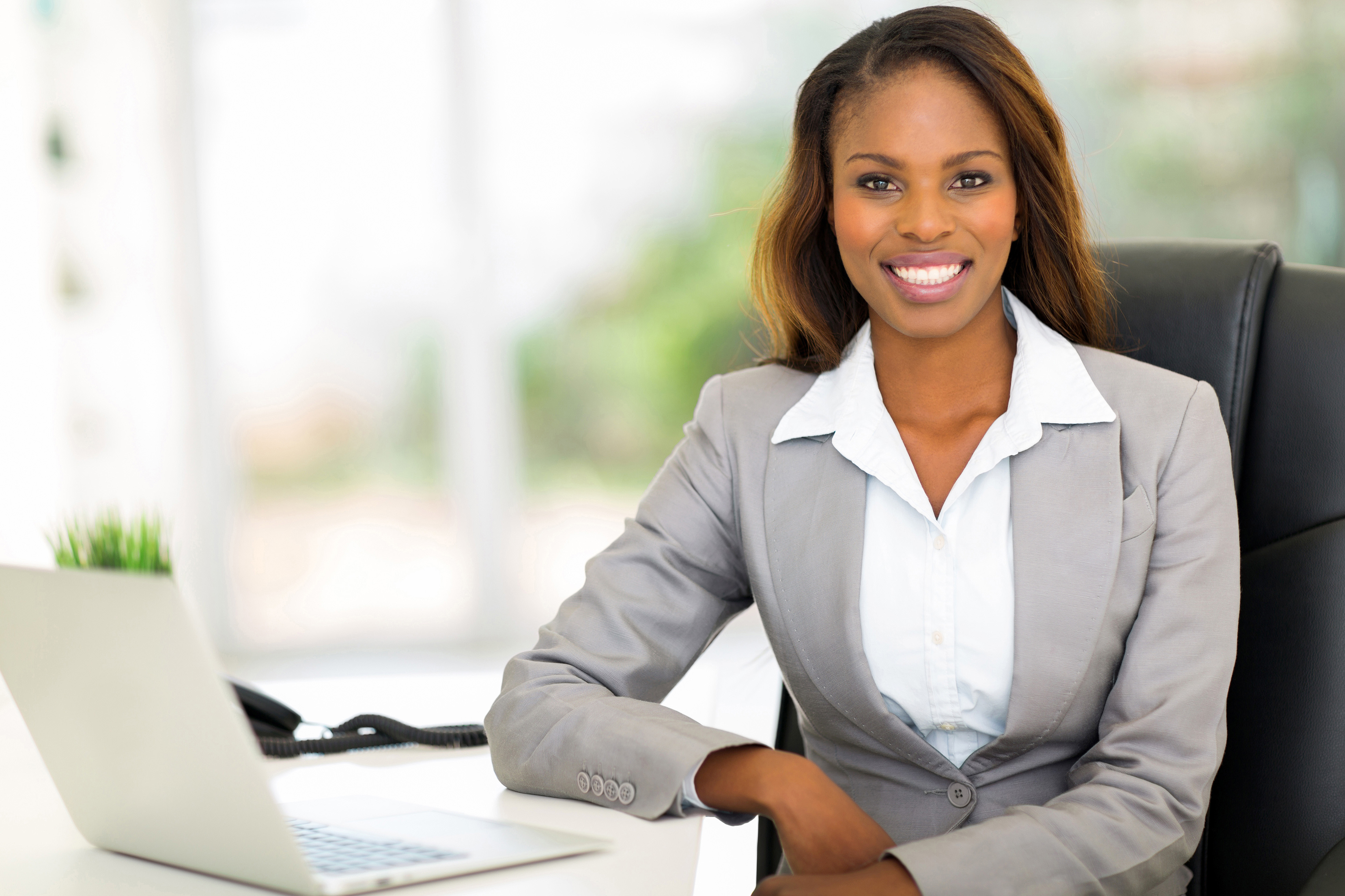 beautiful young afro american businesswoman sitting in office