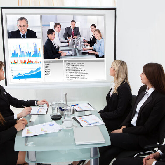 28753871 - businesspeople looking at projector screen in video conference meeting at office